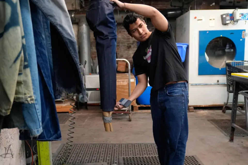 Bryan Morales Ibarra distresses denim by hand at the BPD...