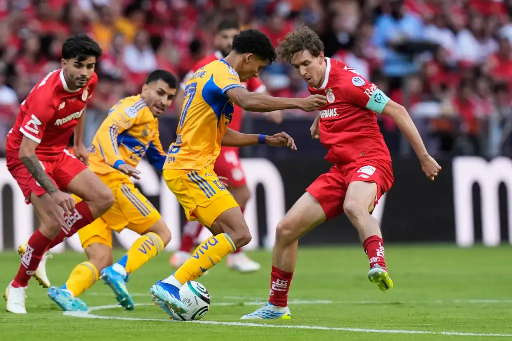 Toluca’s Marcel Ruiz, right, challenges Tigres’ Ozziel Herrera during the...