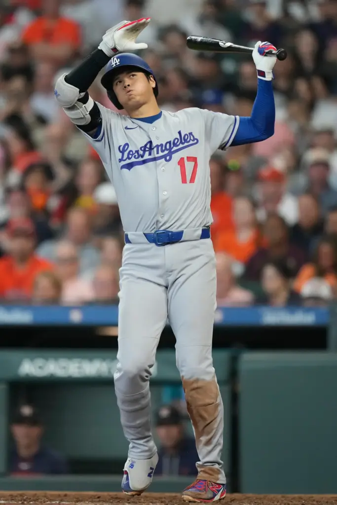 Dodgers star Shohei Ohtani reacts after a swing during the...
