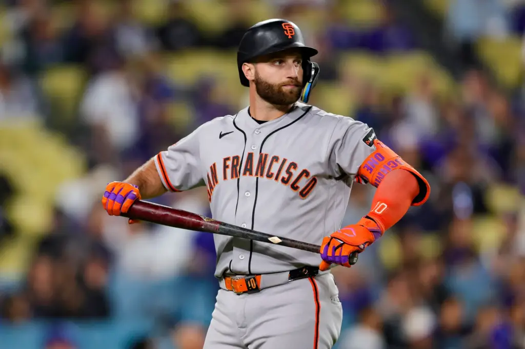 San Francisco Giants designated hitter Casey Schmitt reacts after striking...