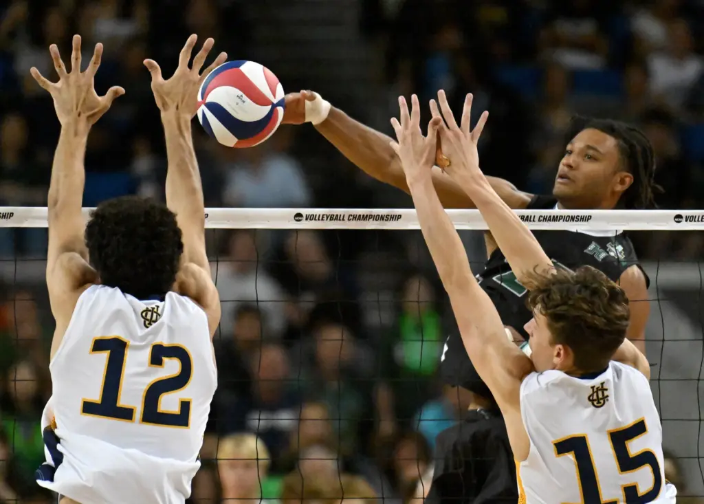 Hawaiiâs Louis Sakanoko, right, spikes the ball during the NCAA...