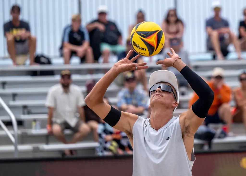 Miles Partain sets the ball while playing with teammate James...