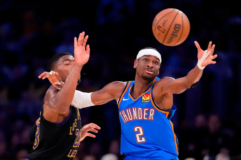 Oklahoma City Thunder guard Shai Gilgeous-Alexander, right, reaches for a...