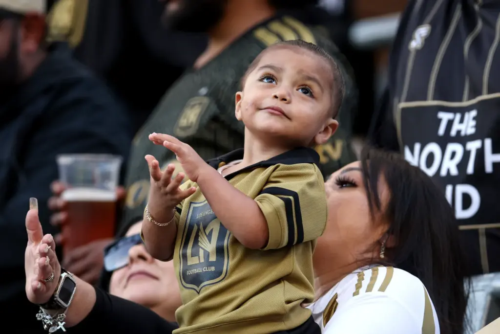 A young Los Angeles FC fan claps during the first...