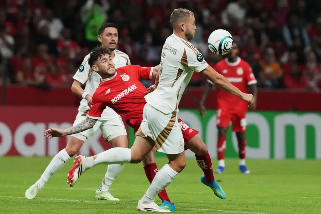 LAFC’s Ryan Porteous, front, and Toluca FC’s Jesus Angulo vie...