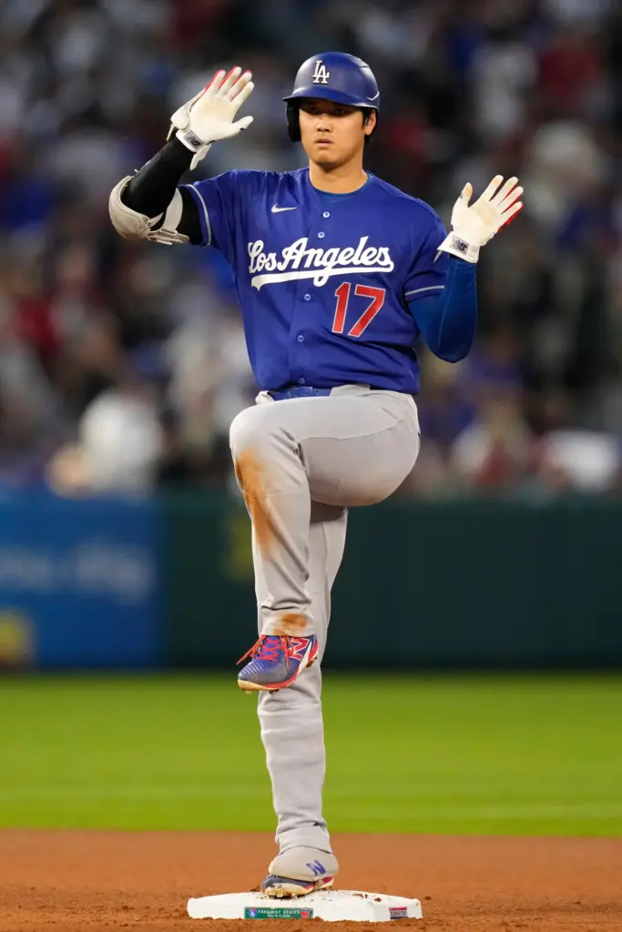 Dodgers star Shohei Ohtani gestures toward his dugout after hitting...