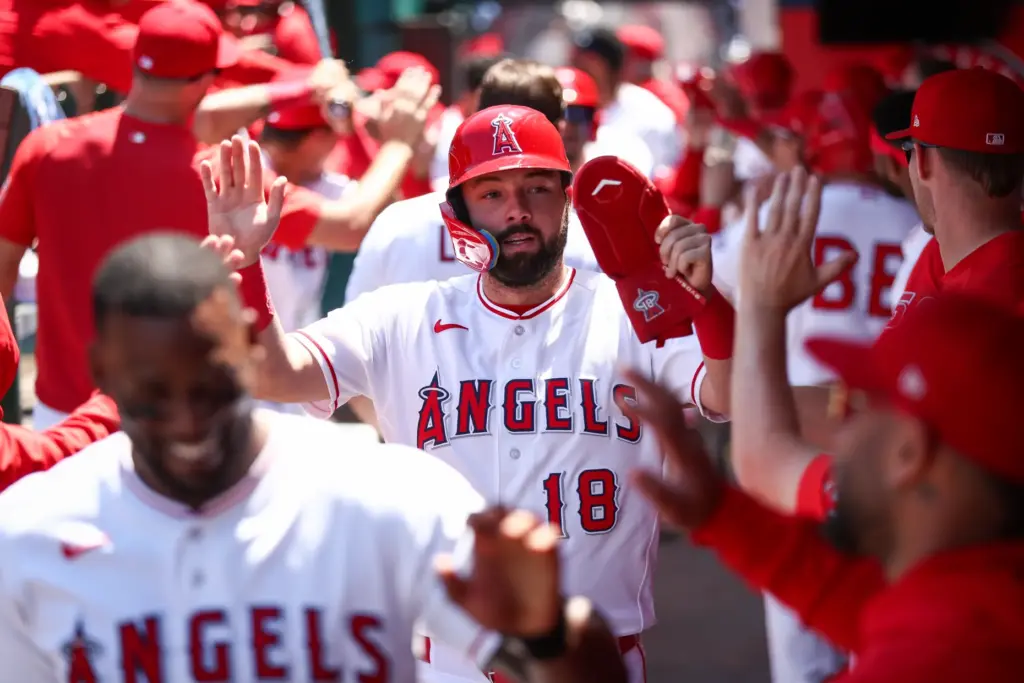 The Angels’ Nolan Schanuel celebrates with teammates in the dugout...