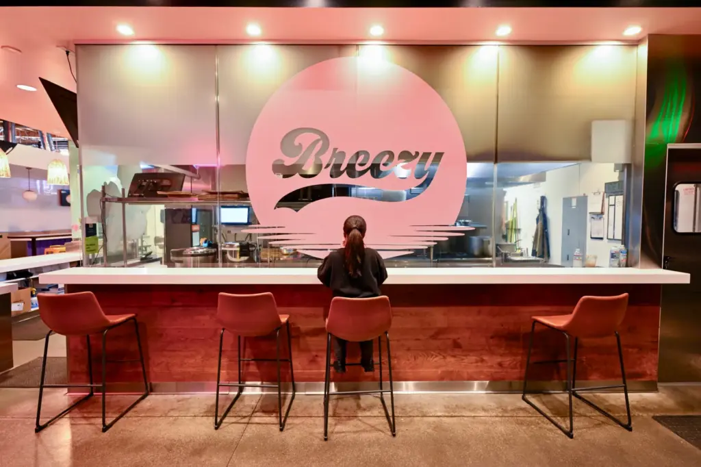 A woman eats lunch at Rodeo 39 food hall in...