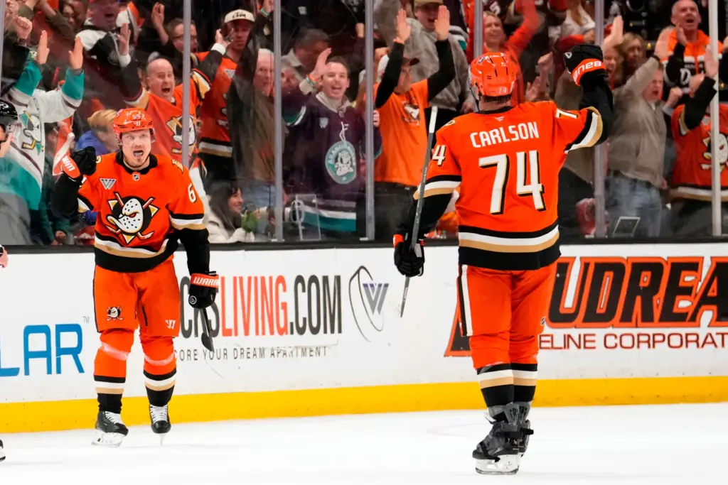 Ducks center Mikael Granlund, left, celebrates his goal with defenseman...