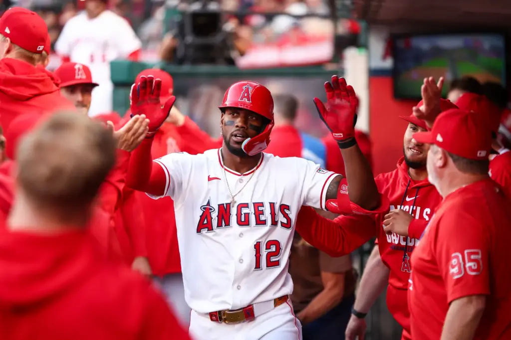The Angels’ Jorge Soler celebrates in the dugout after hitting...