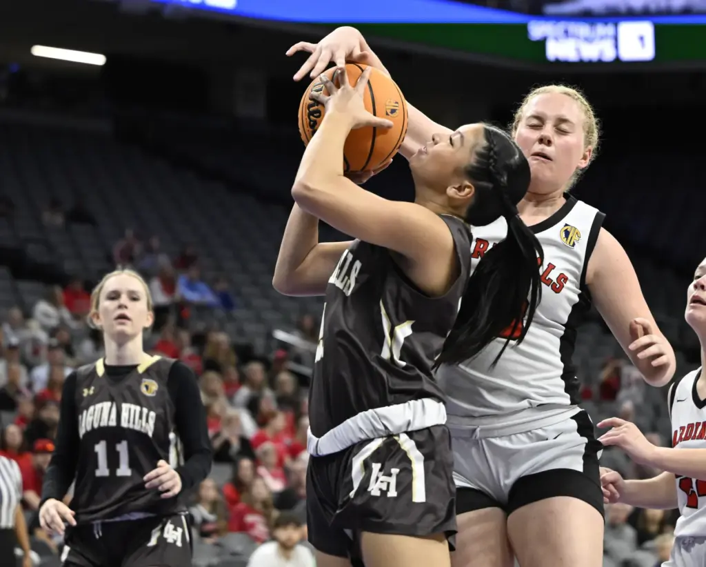 Siena Sorbello #20 of Woodland Christian rebounds blocks TJ shot...