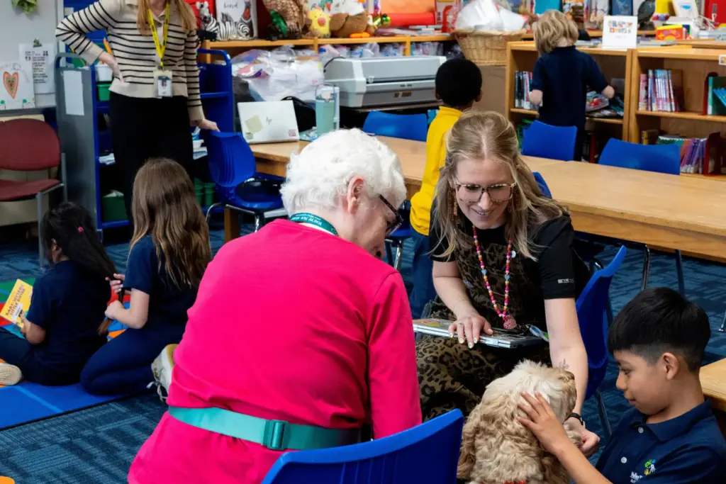 Ian, right, and school social worker Nicole Herje pet Sage,...