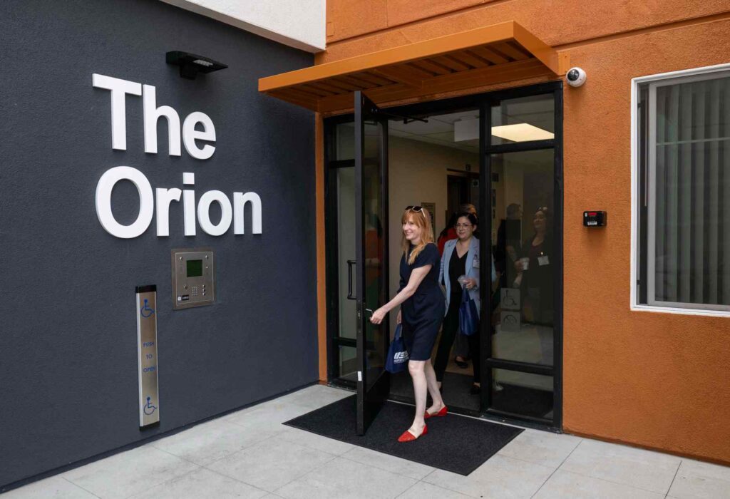 People tour The Orion low-income apartment community for residents 55...