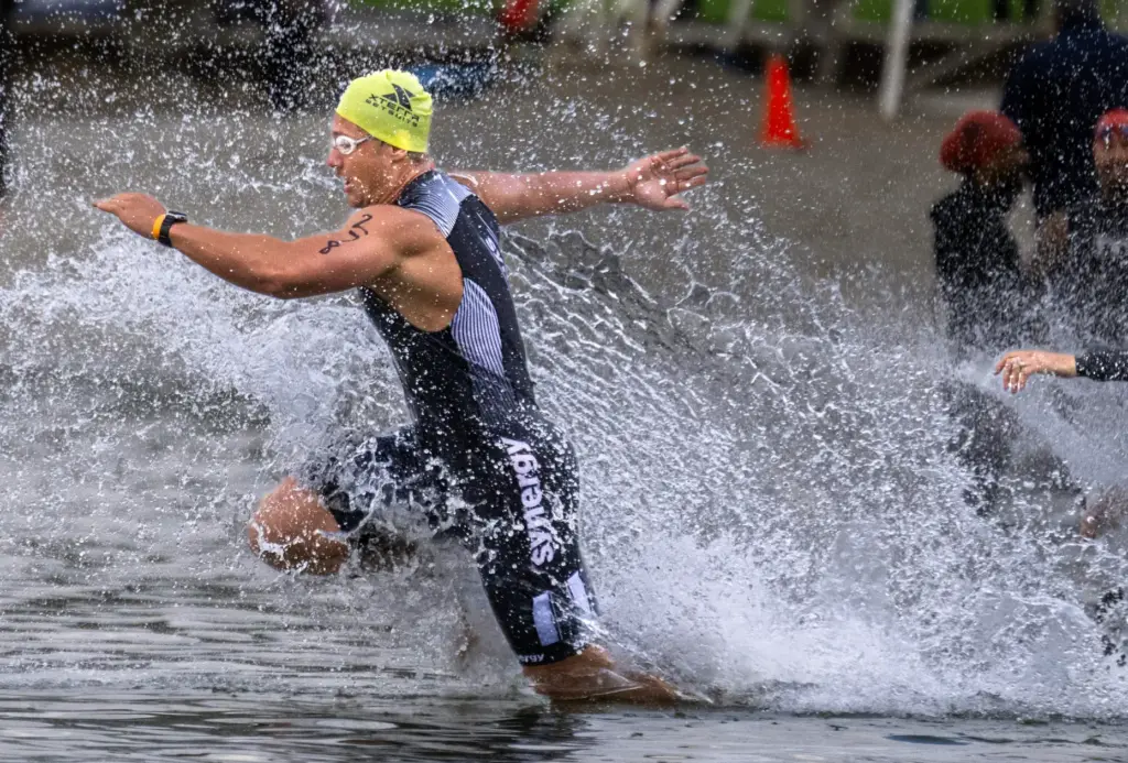 Ivan Tkach, an OC Tri Series Olympic distance swimmer, hits...