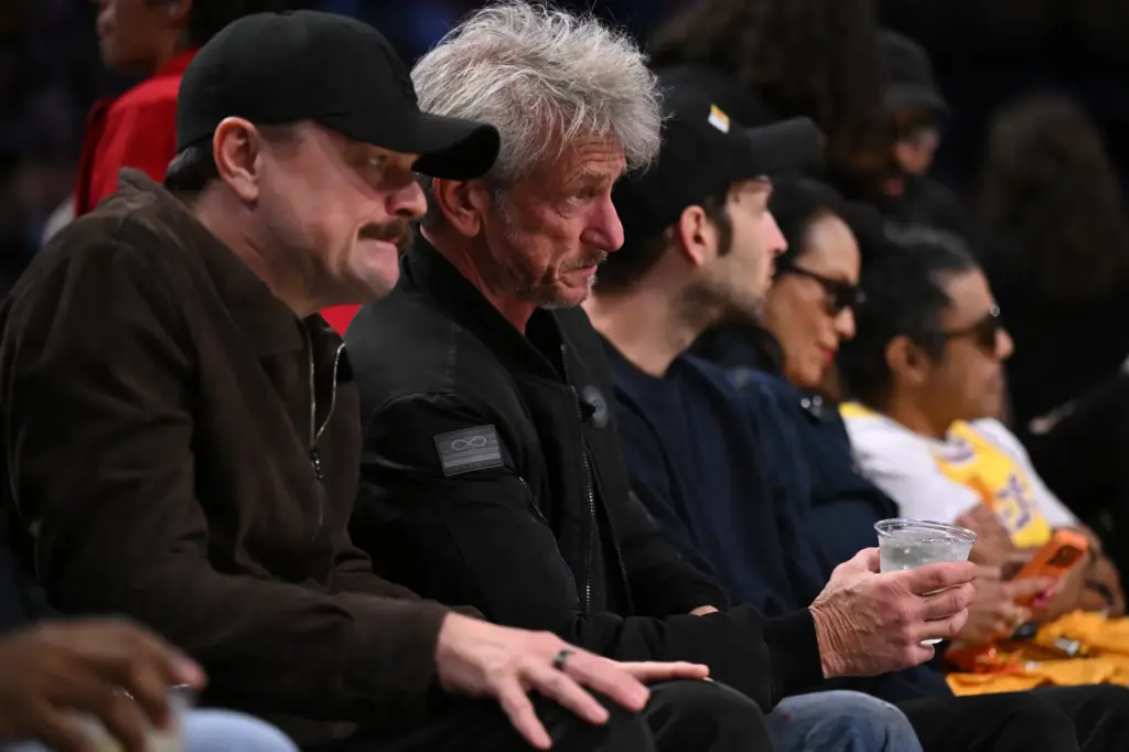 Actors Leonardo DiCaprio, left, and Sean Penn watch Game 4...