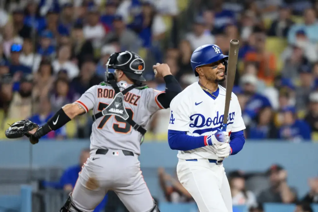 The Dodgers’ Mookie Betts, right, reacts after he struck out...