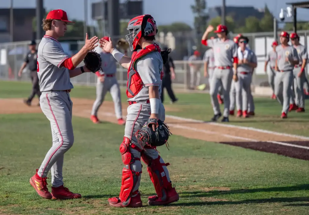 Orange Lutheranâs Sam Principe, left, who pitched the whole game,...