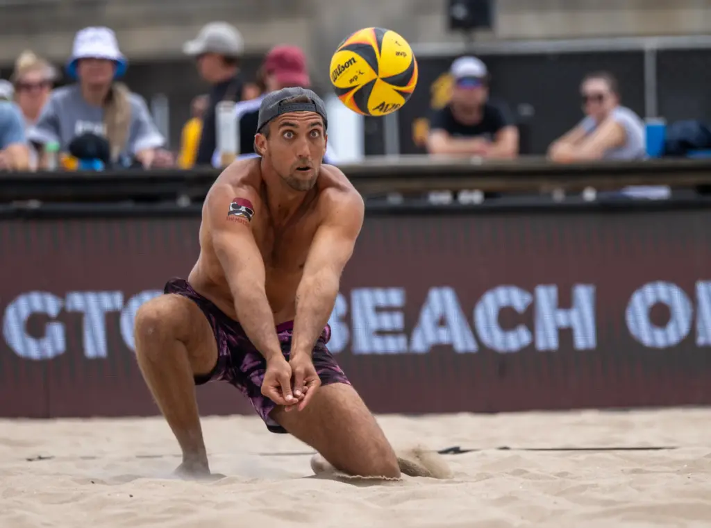 Trevor Crabb digs the ball while playing with teammate Phil...