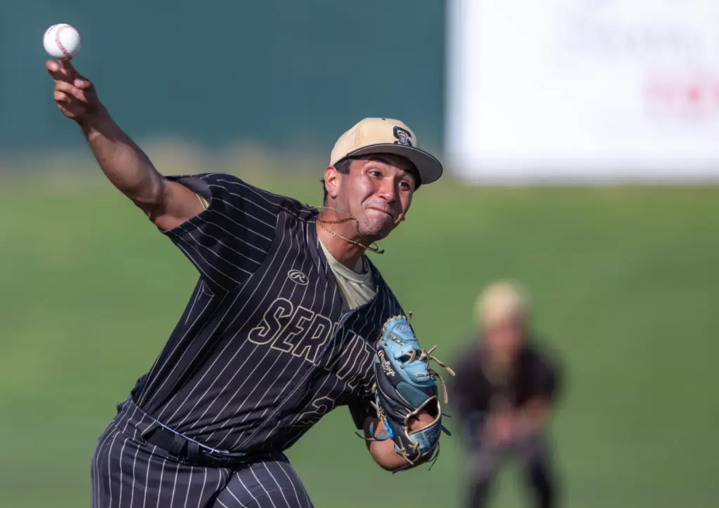 Servite relief pitcher Isaiah Camacho throws to home plate during...