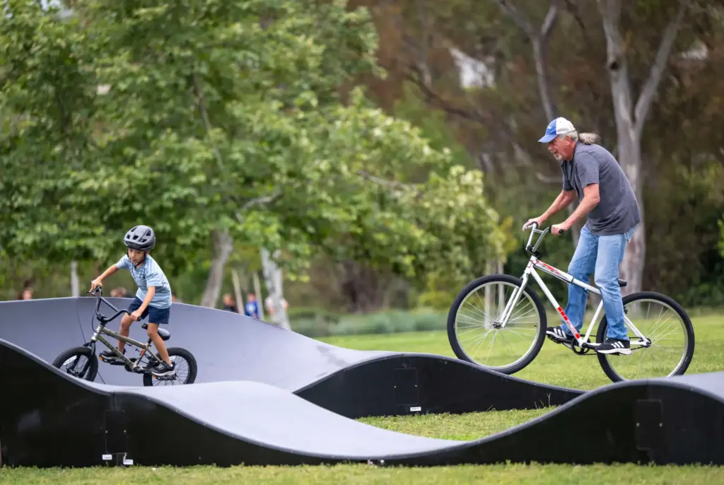 Ken Tenborg, right, of Mission Viejo rides his bike on...