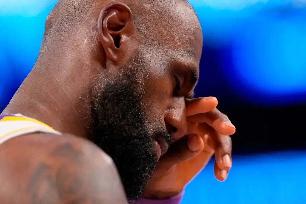 Lakers star LeBron James wipes his eye during the closing...