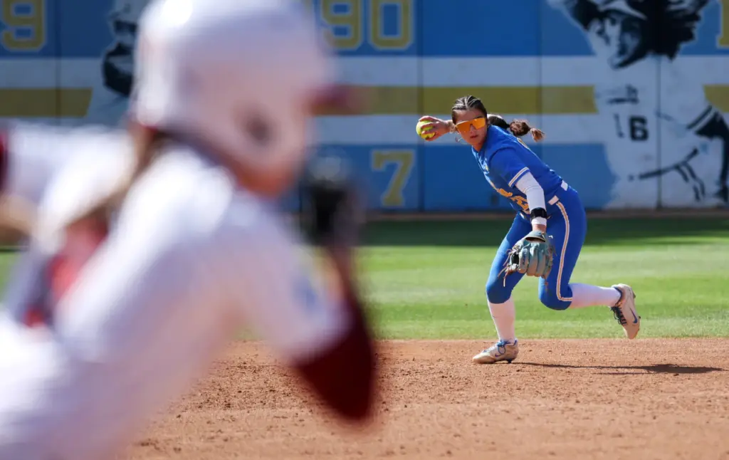 UCLAâs Aleena Garcia prepares to toss the ball to first...