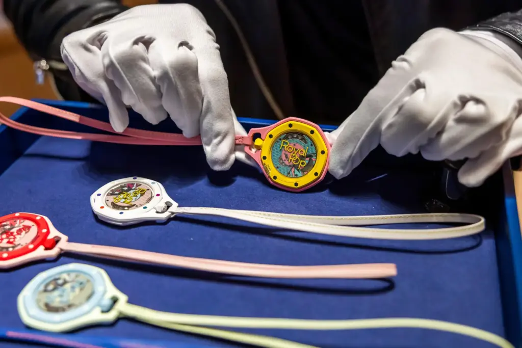 A saleswoman shows the new Royal Pop watch by Swatch...