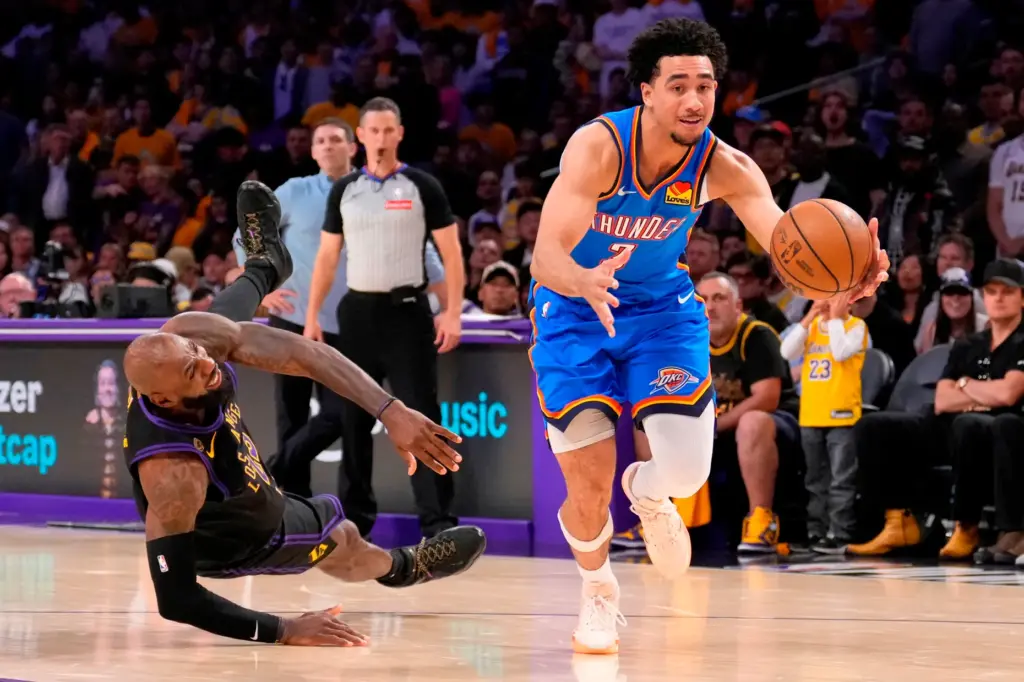 Oklahoma City Thunder guard Jared McCain, right, drives toward the...