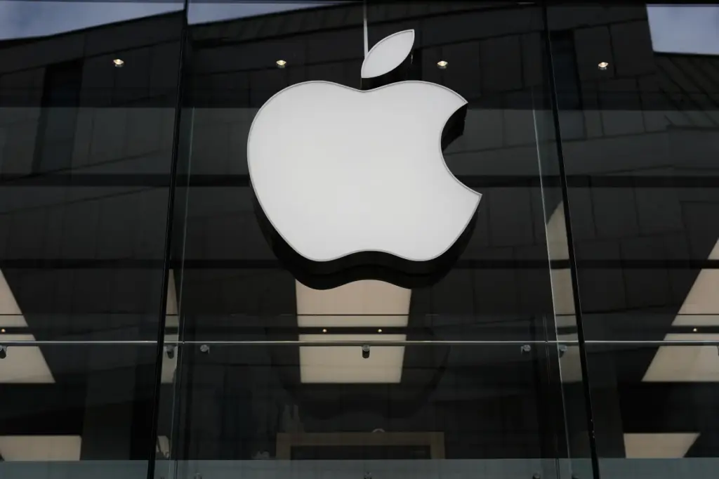 The Apple logo is illuminated at a store in Munich, Germany.