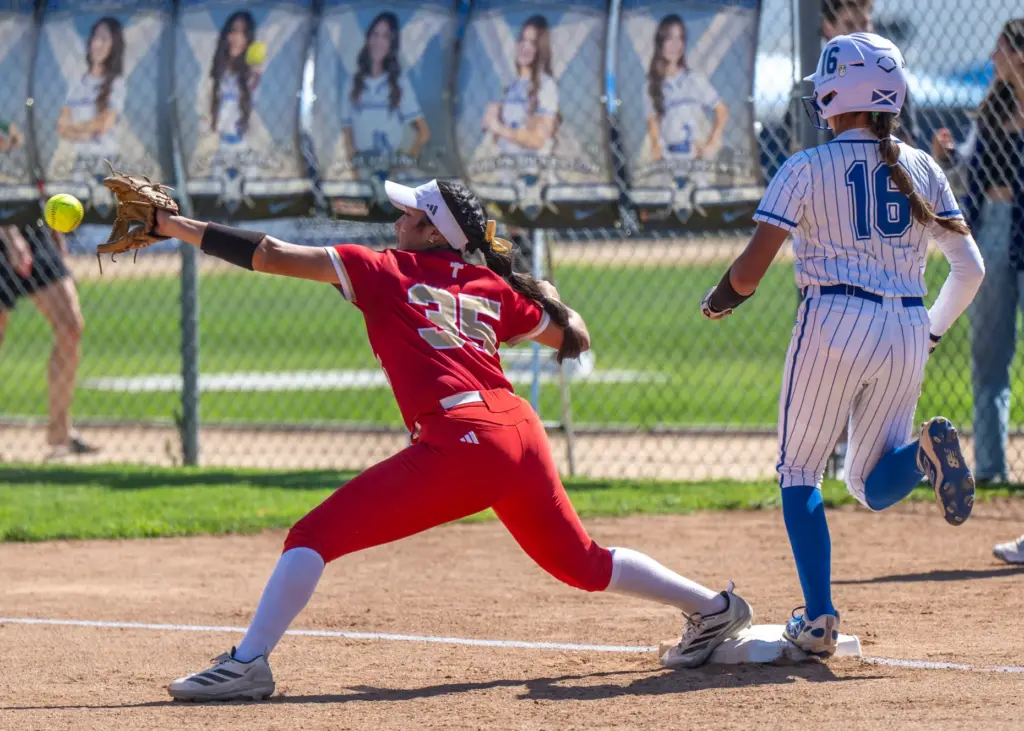 Orange Lutheran outfielder Alyssa Hernandez gets safely to first base...