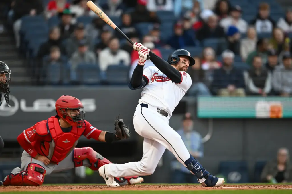 The Cleveland Guardians’ Daniel Schneemann hits a two-run single during...