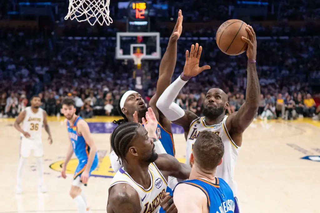Lakers star LeBron James goes up for a shot as...