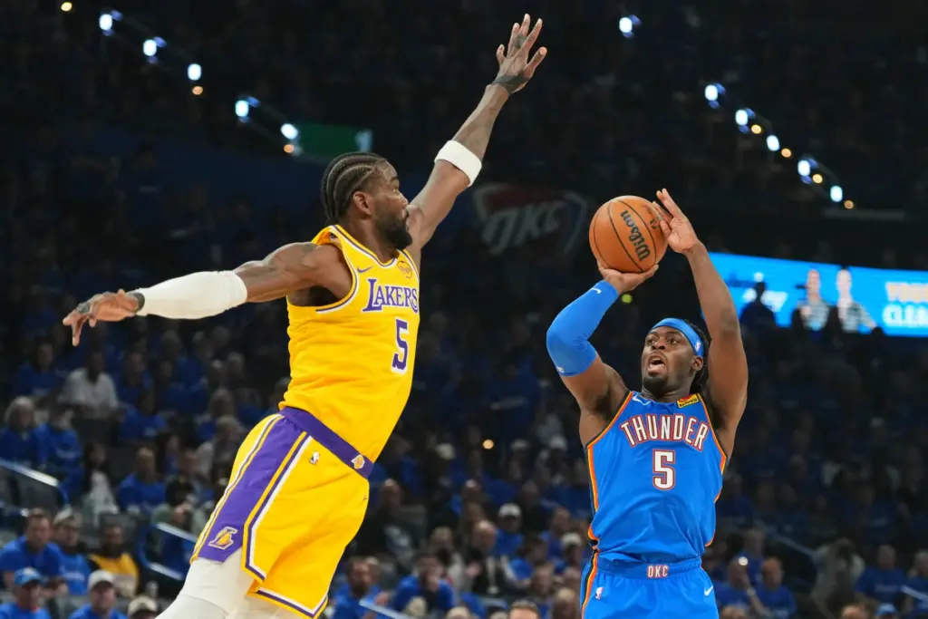 Oklahoma City Thunder guard Luguentz Dort, right, shoots as Lakers...