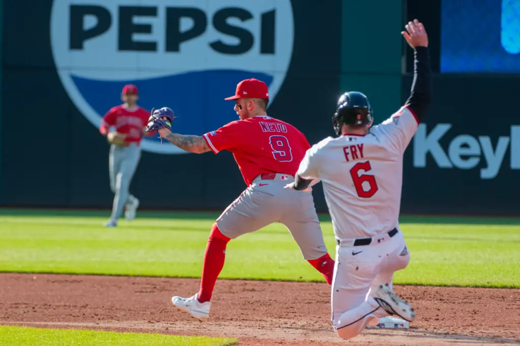 Angels shortstop Zach Neto, left, forces out the Cleveland Guardians’...