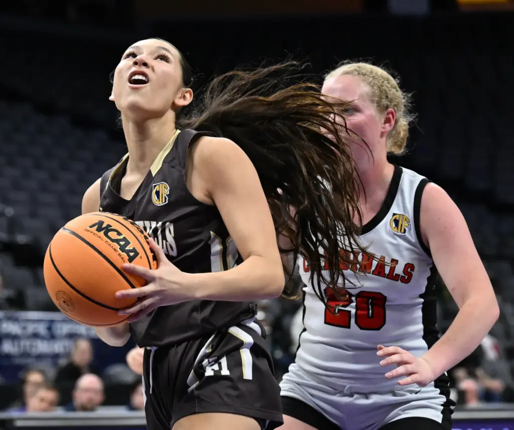 Lena Goodman #13 of Laguna Hills drives to the basket...