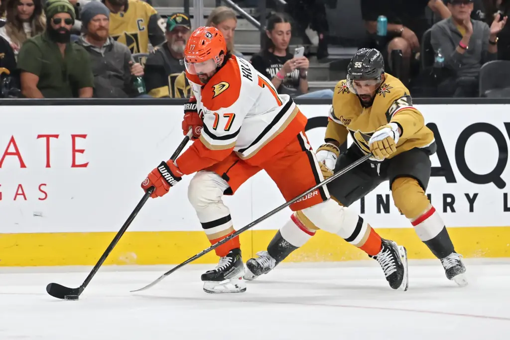 The Ducks’ Alex Killorn, left, skates with the puck as...