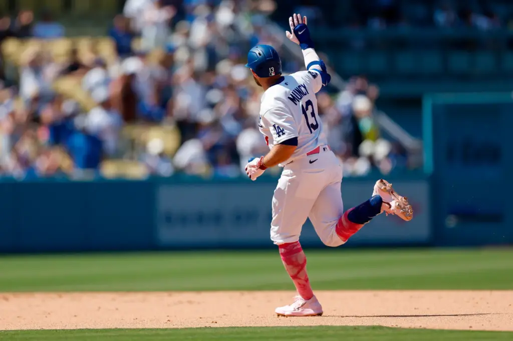 Dodgers’ Max Muncy rounds the bases after hitting a two-run...
