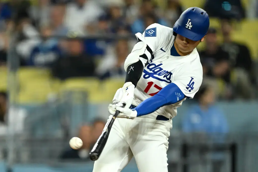 Dodgers star Shohei Ohtani hits a fly ball for an...