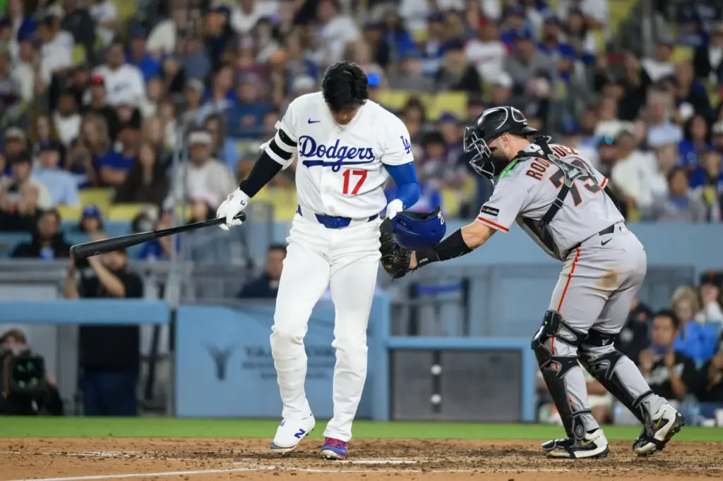 Dodgers star Shohei Ohtani is tagged by San Francisco Giants...