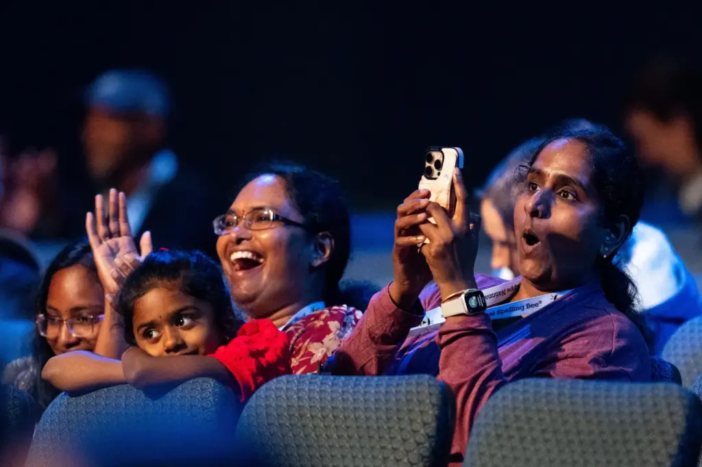 Parents in the audience watch closely during the quarterfinals of...