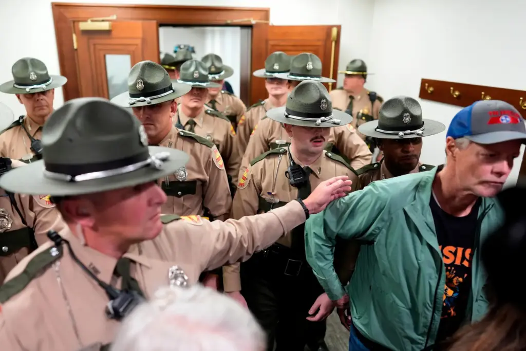 State troopers clear a House committee meeting after it was disrupted by protesters.