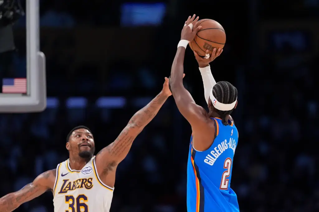 Oklahoma City Thunder guard Shai Gilgeous-Alexander, right, shoots as Lakers...