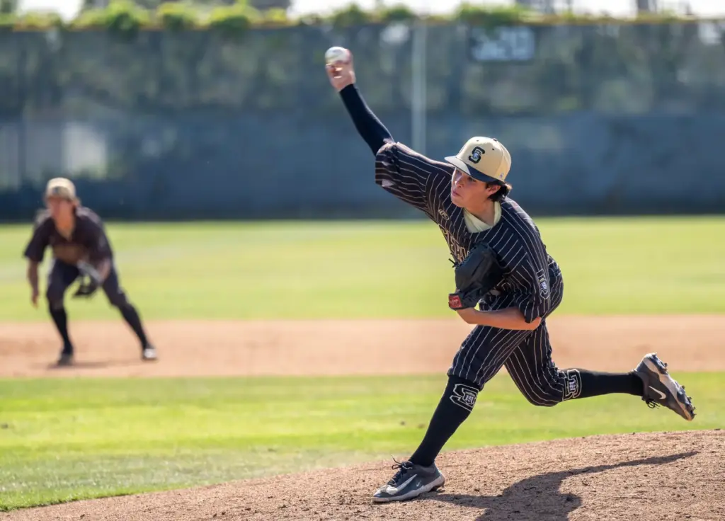 Servite starting pitcher Cole Grosthues throws to home plate during...