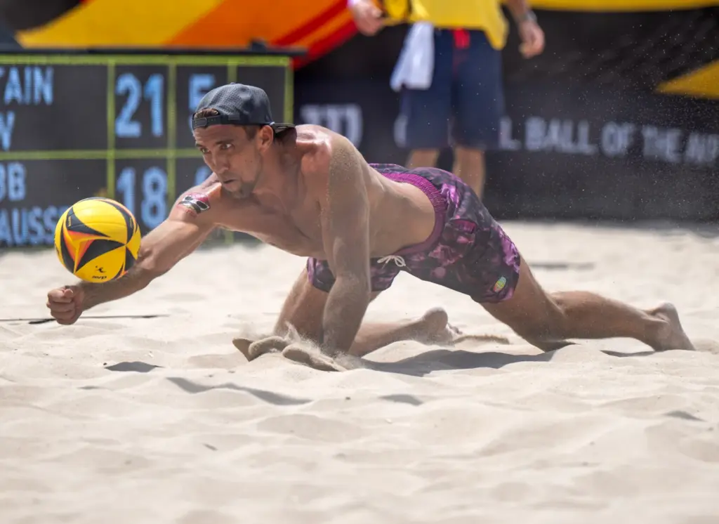 Trevor Crabb digs the ball while playing with teammate Phil...