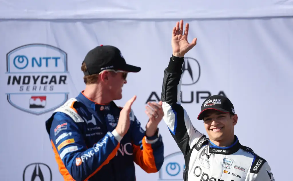 Indycar driver Alex Palou, right, waves behind Scott Dixon after...
