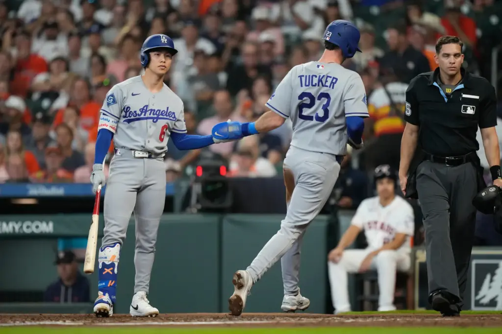The Dodgers’ Kyle Tucker (23) celebrates with teammate Hyeseong Kim...