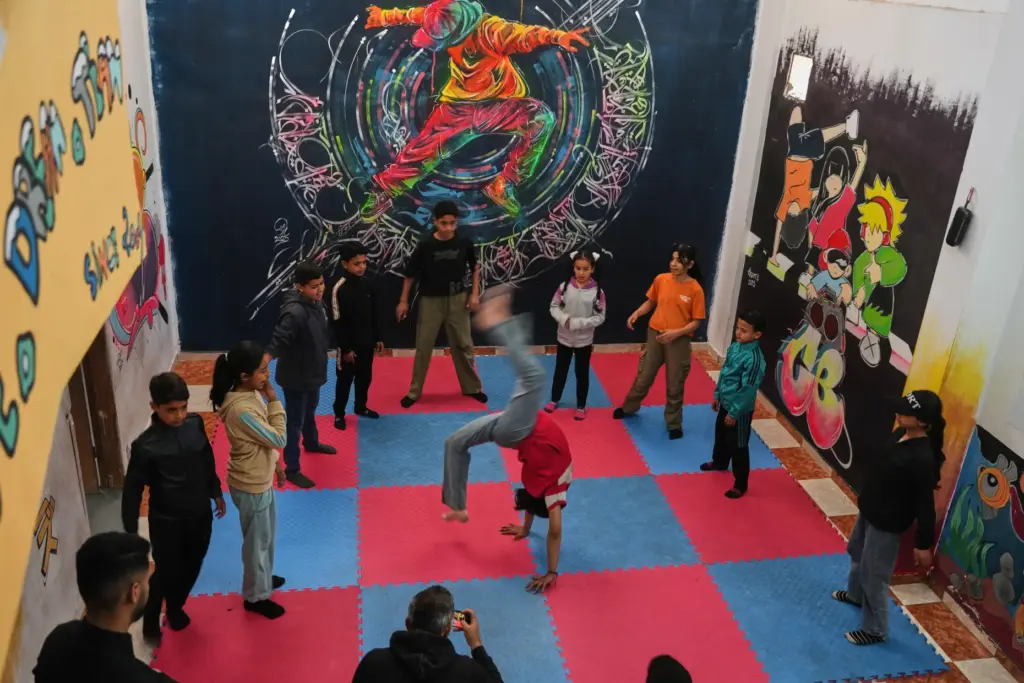 Palestinian children practice breakdancing