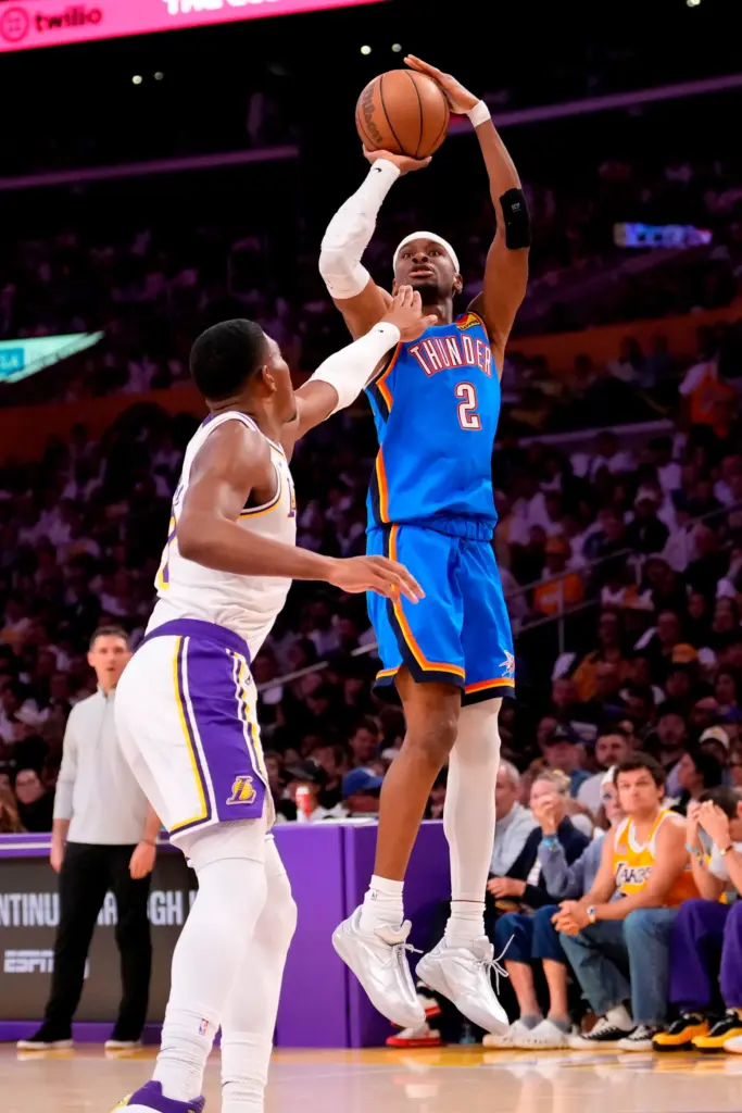 Oklahoma City Thunder guard Shai Gilgeous-Alexander, right, shoots as Lakers...
