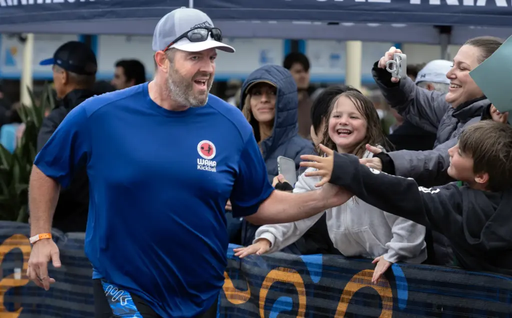 Scott Haydon is greeted at the finish line by his...