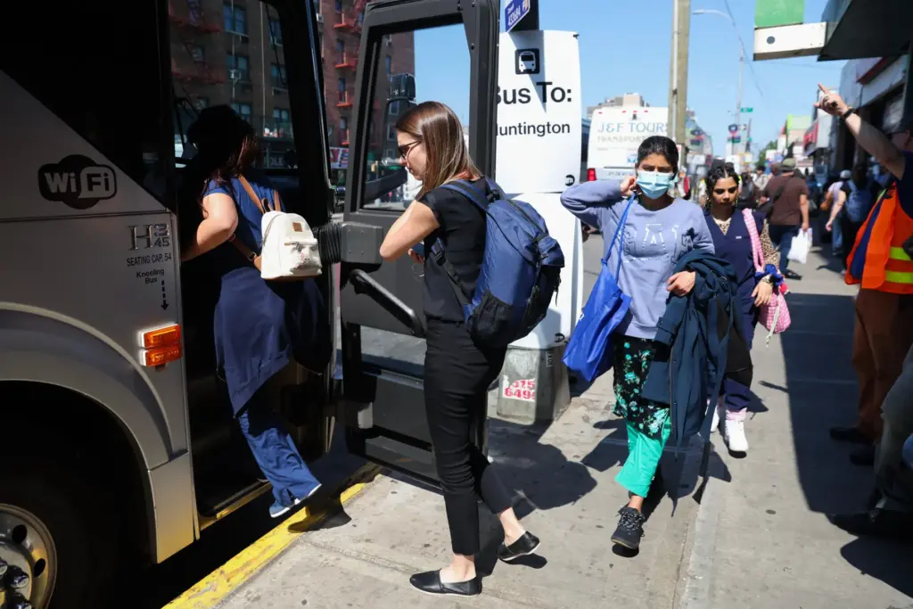 Commuters board buses to Long Island outside of the Jamaicaâ179th Street station.